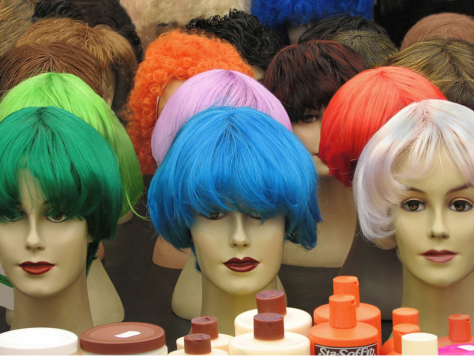 A colorful display of wigs and hair care products at the Albert Cuyp market.