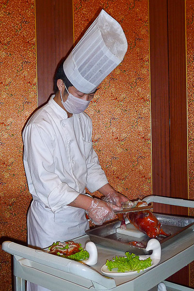 A hotel chef prepares our dinner in our group's private dining room.