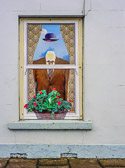 This painted window in Bushmill brings to mind the art of Magritte.