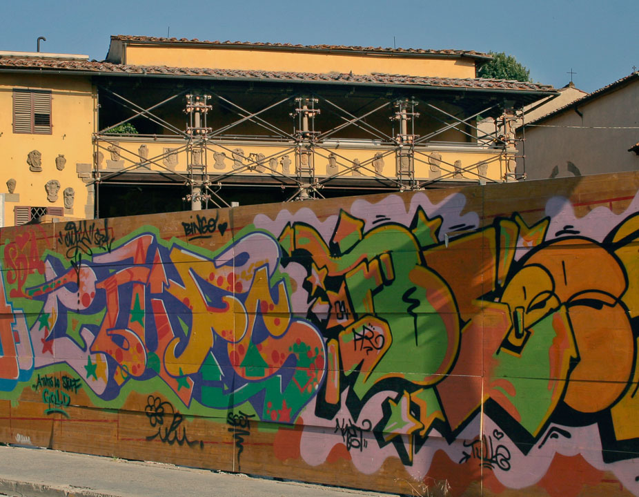 The plywood walls around a Fiosole construction site is a show place for the grafitti artists.