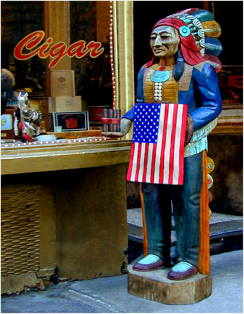 A cigar store indian in  Little Italy holds the American flag after 9/11.