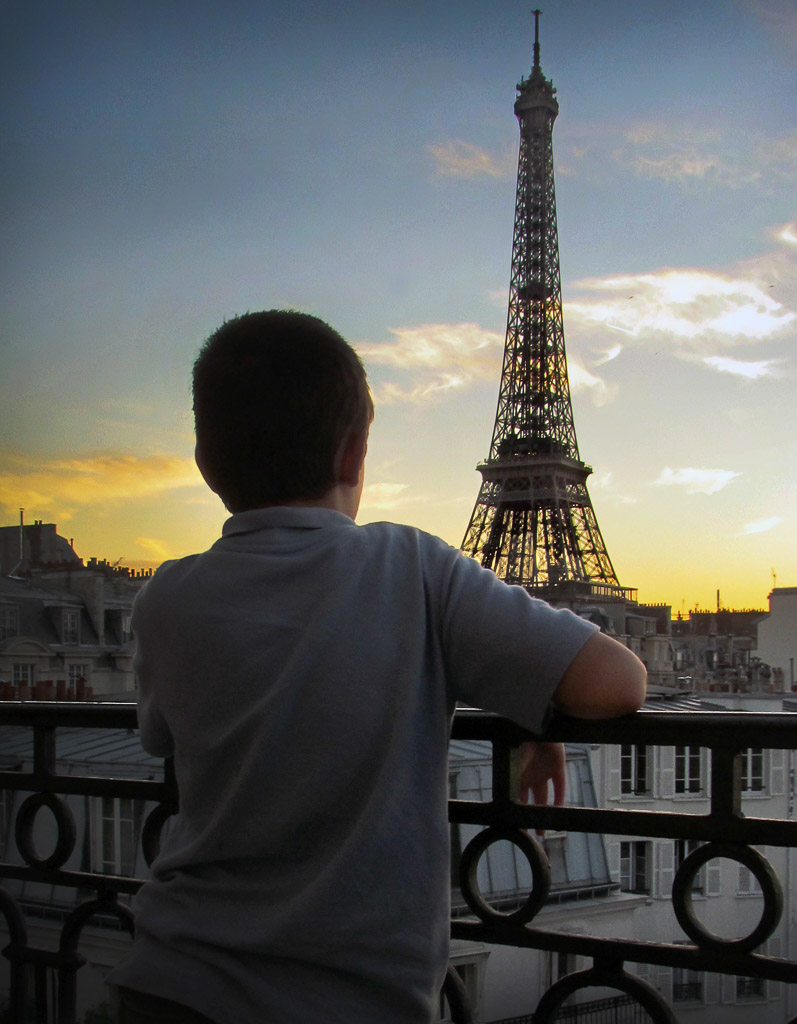 He's captivated by the  view of the tower as he waits for the after sundown light show.