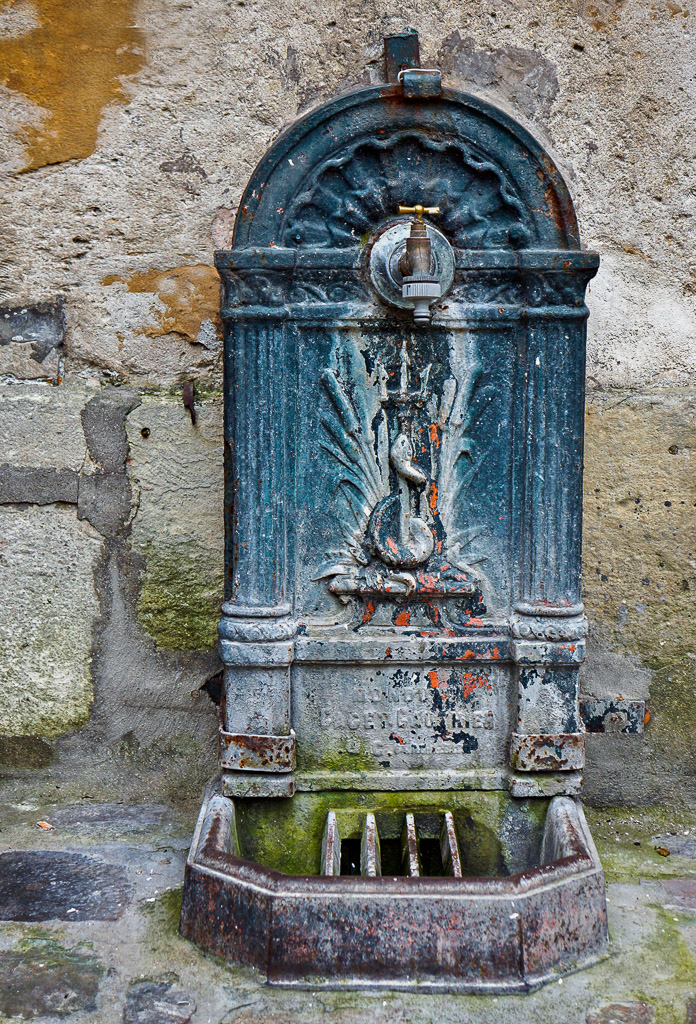 An old fountain in an apartment courtyard at the Place Des Vosges.