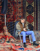The rug merchant's assistant at the antique market .